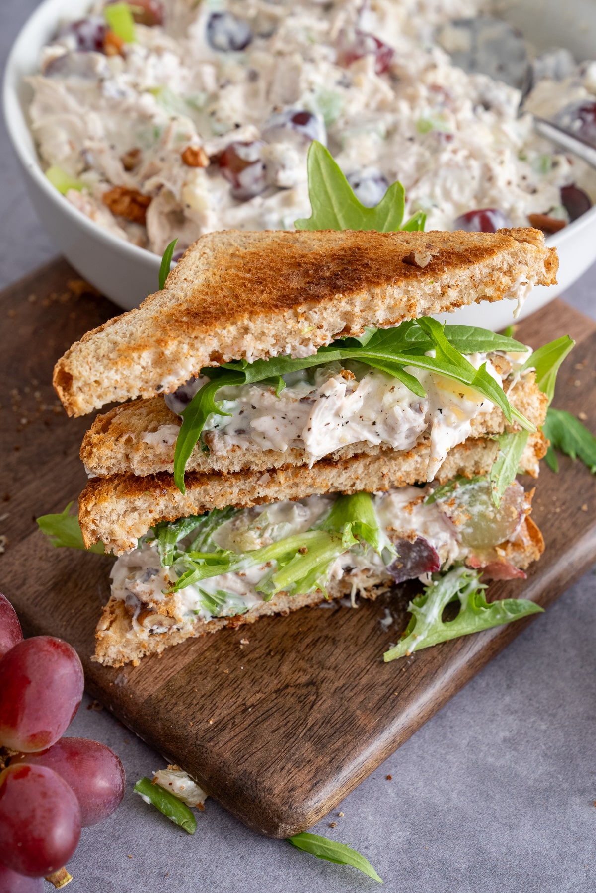 fruity chicken salad on bread with fruit around it