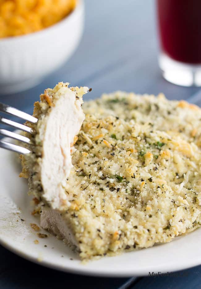 Chicken on white plate cut and piece on fork 