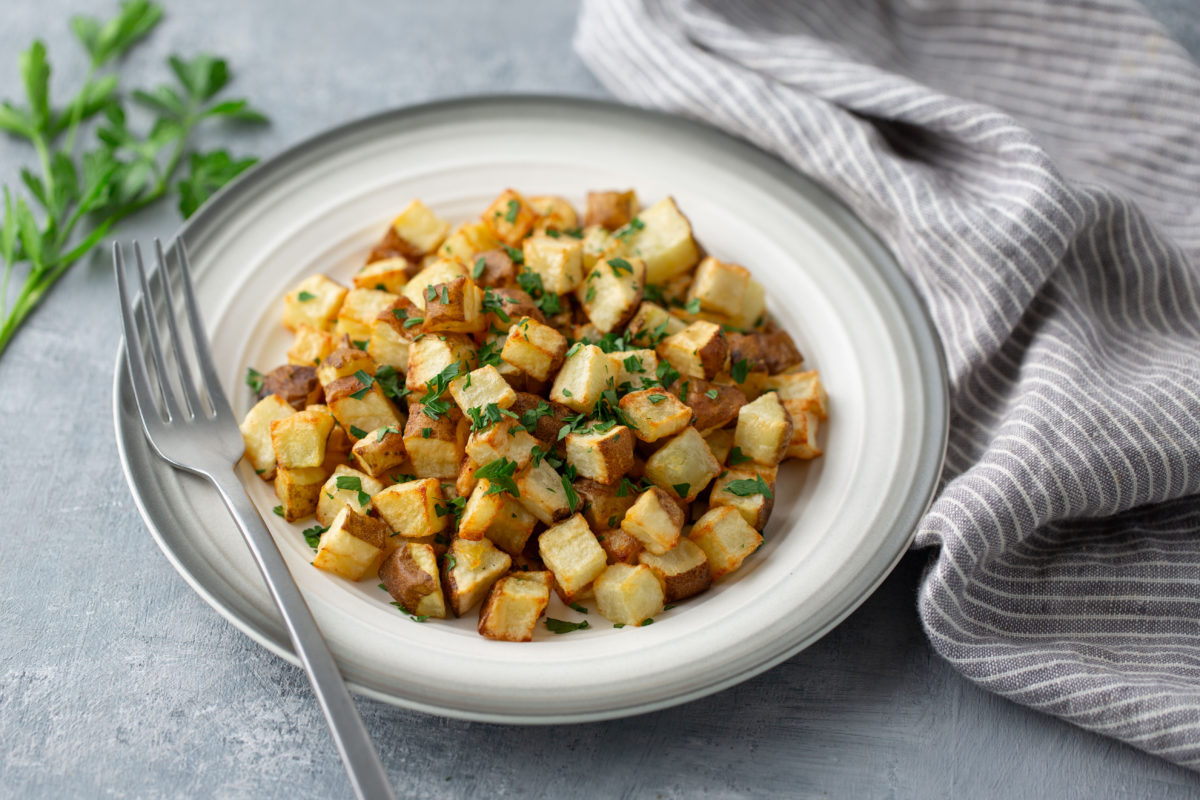 roasted potatoes on plate with fork on side