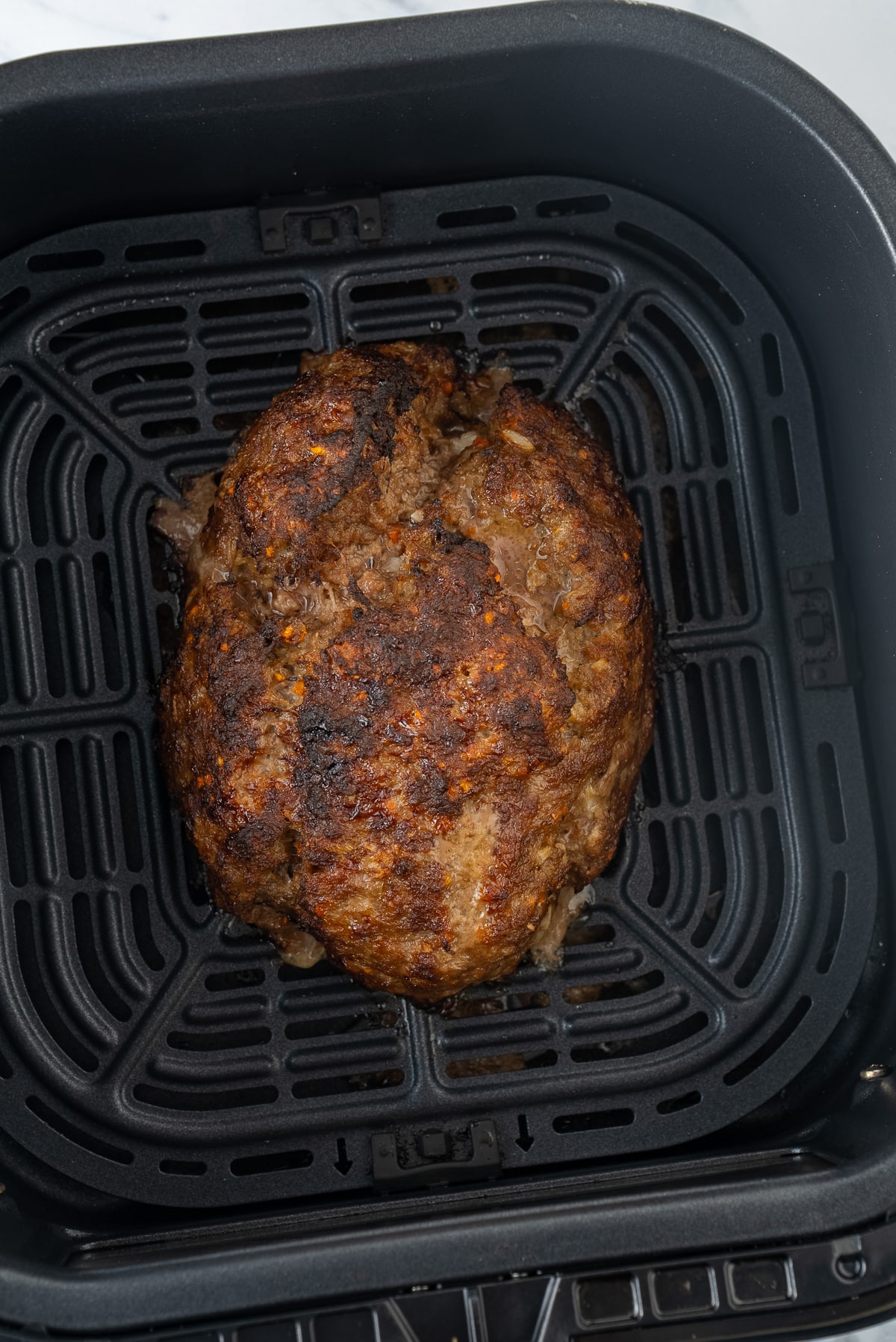 cooked meatloaf in air fryer basket