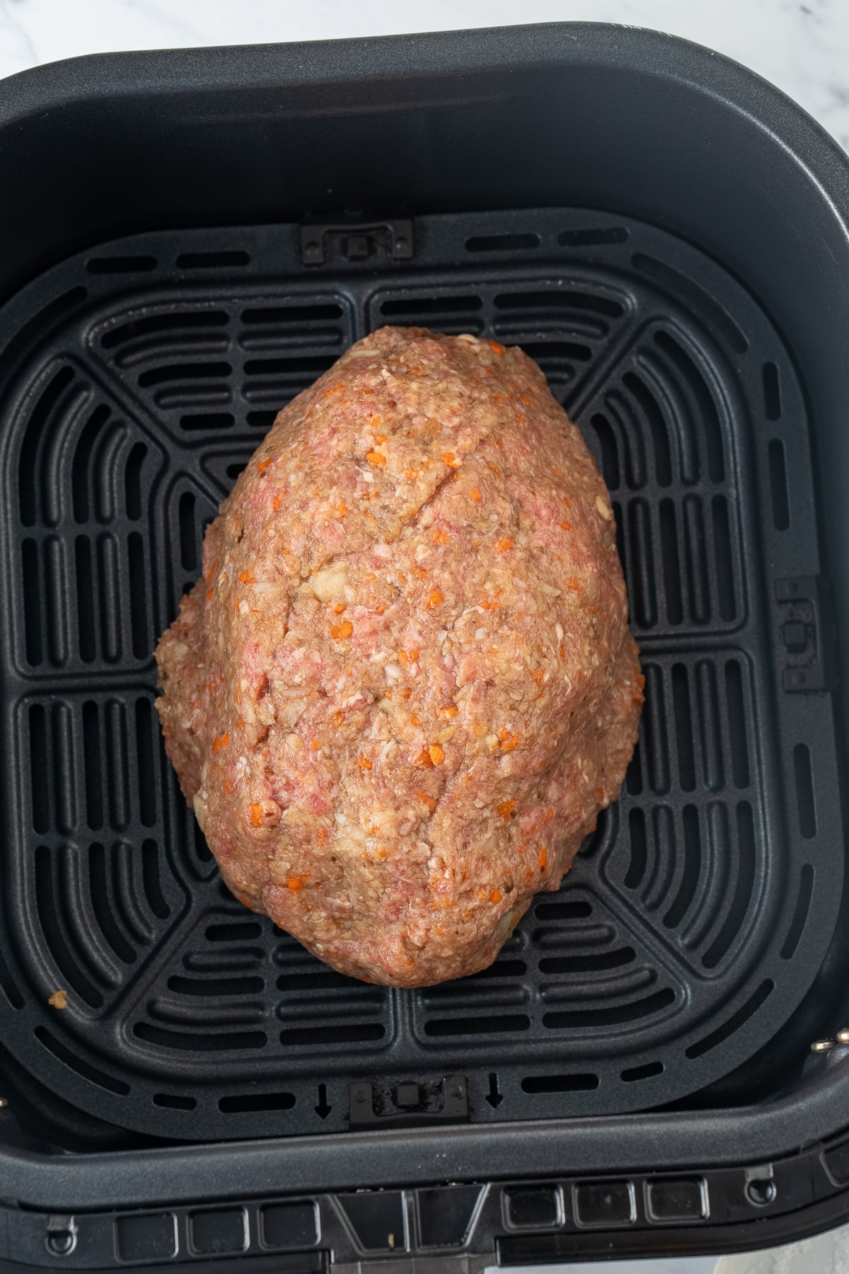 raw meatloaf in air fryer basket