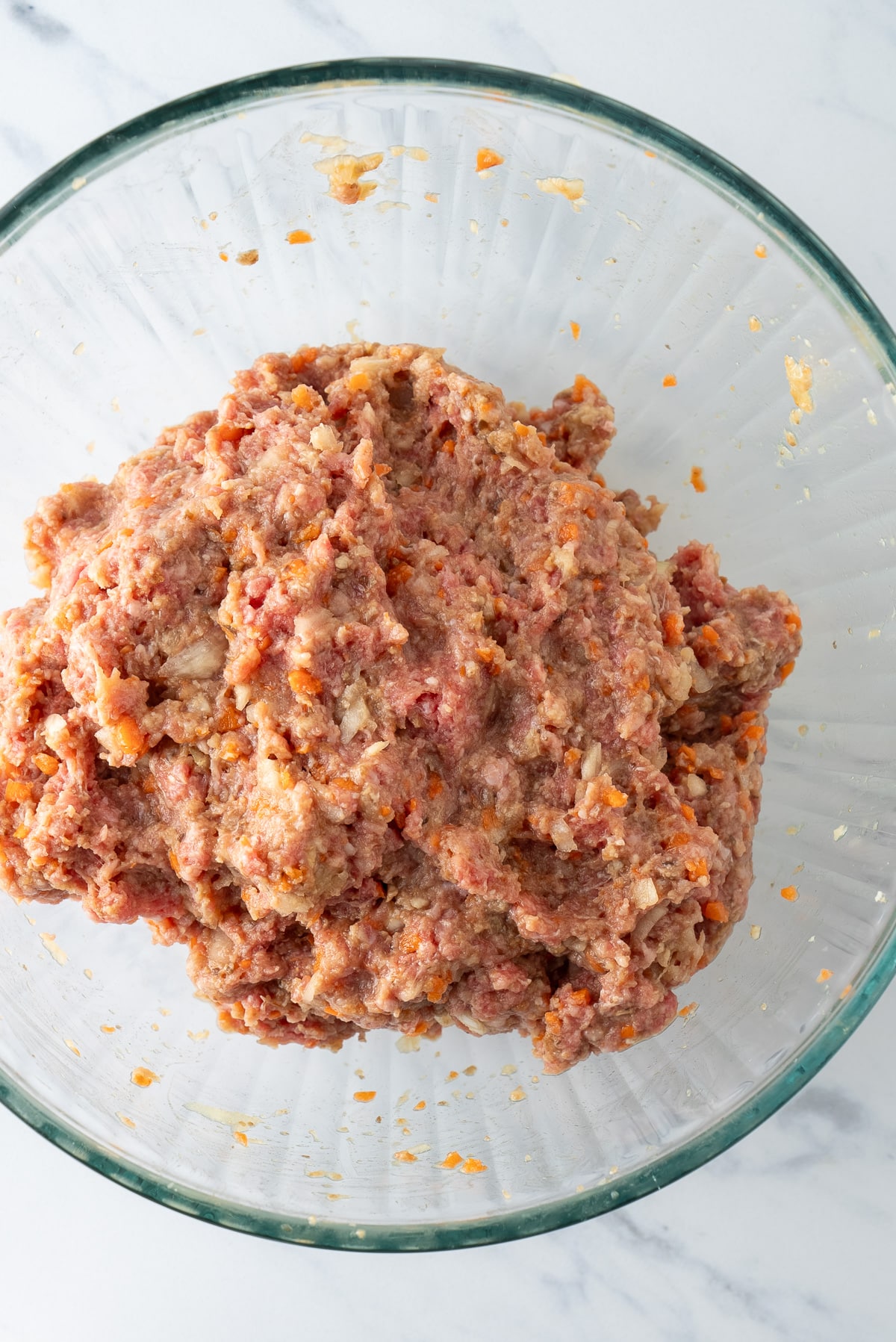 mixed raw meat and vegetables for meatloaf