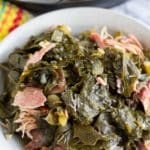 collard greens in plate with bottom of instant pot in background