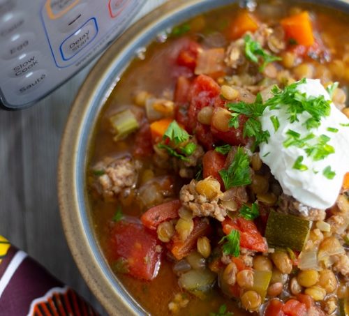 final photo shot of pressure cooker lentil soup with sour cream on top