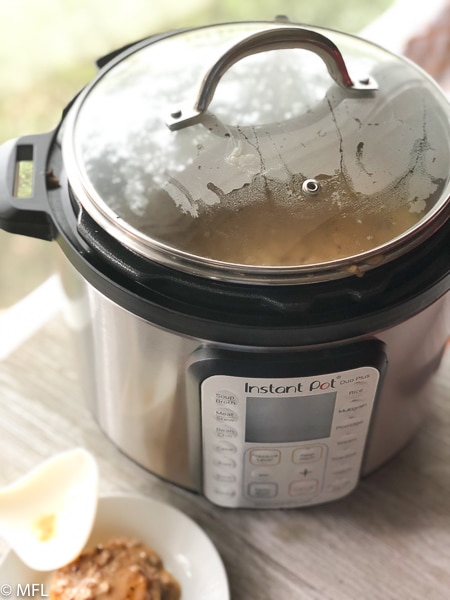 instant pot covered with glass lid near window