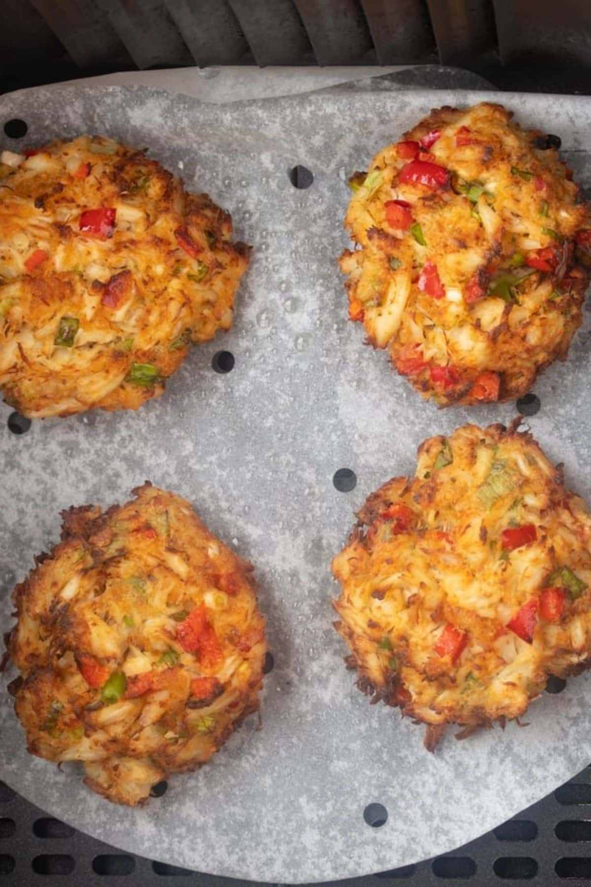 cooked air fryer crab cakes in an air fryer basket