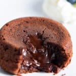 molten lava cake on white plate with blueberries in background