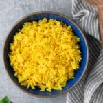 yellow rice in blue plate