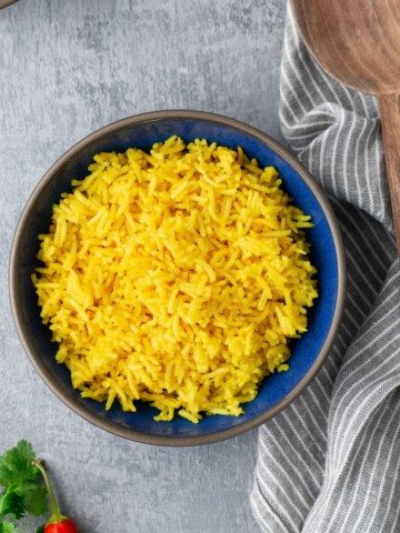 yellow rice in blue plate