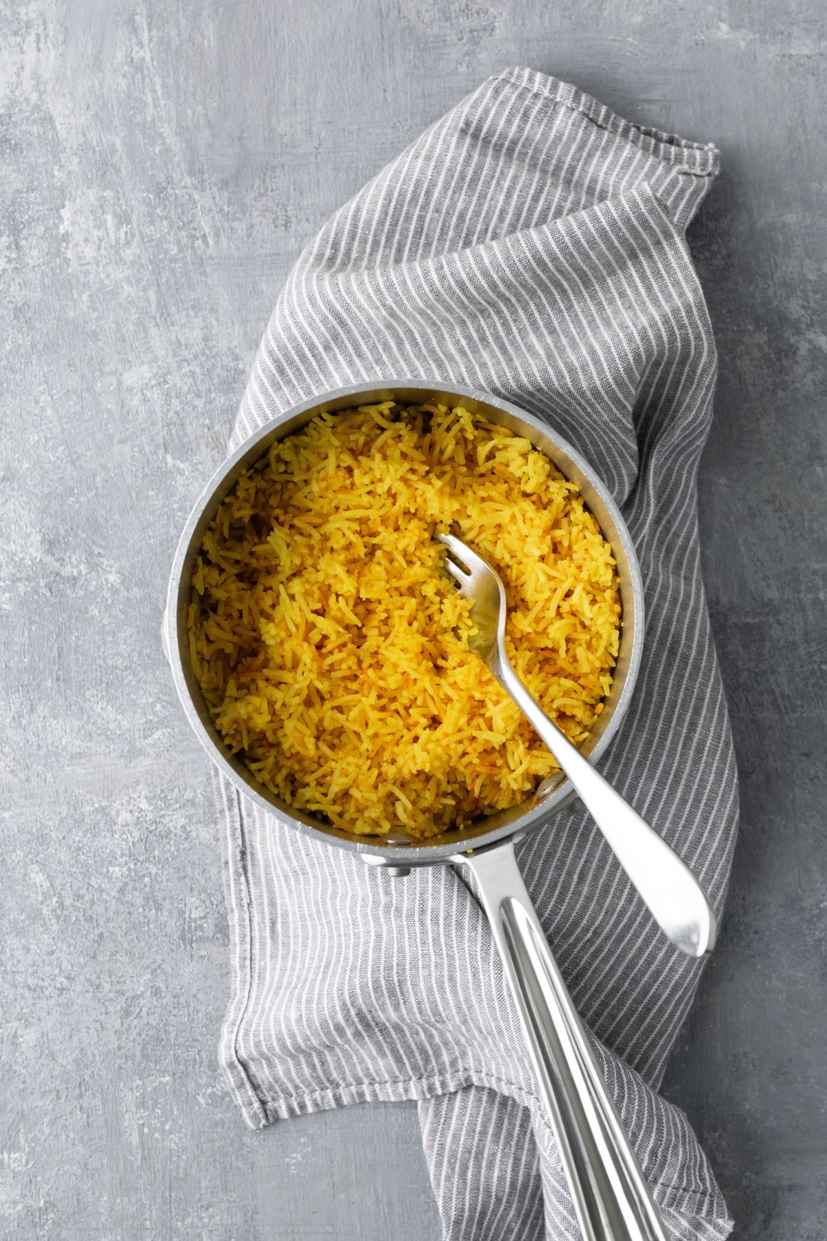 fork fluffing yellow rice