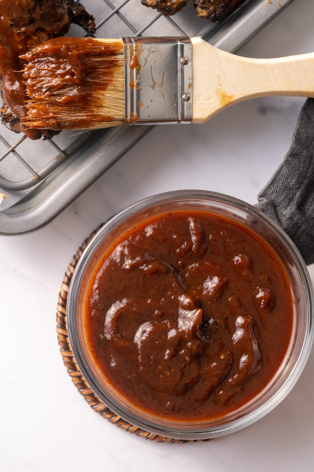 BBQ sauce in glass jar with brush on side of it