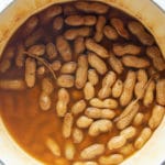 The cooked peanuts in a large pot.