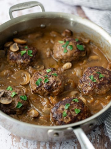 salisbury steak with gravy with parsley on top