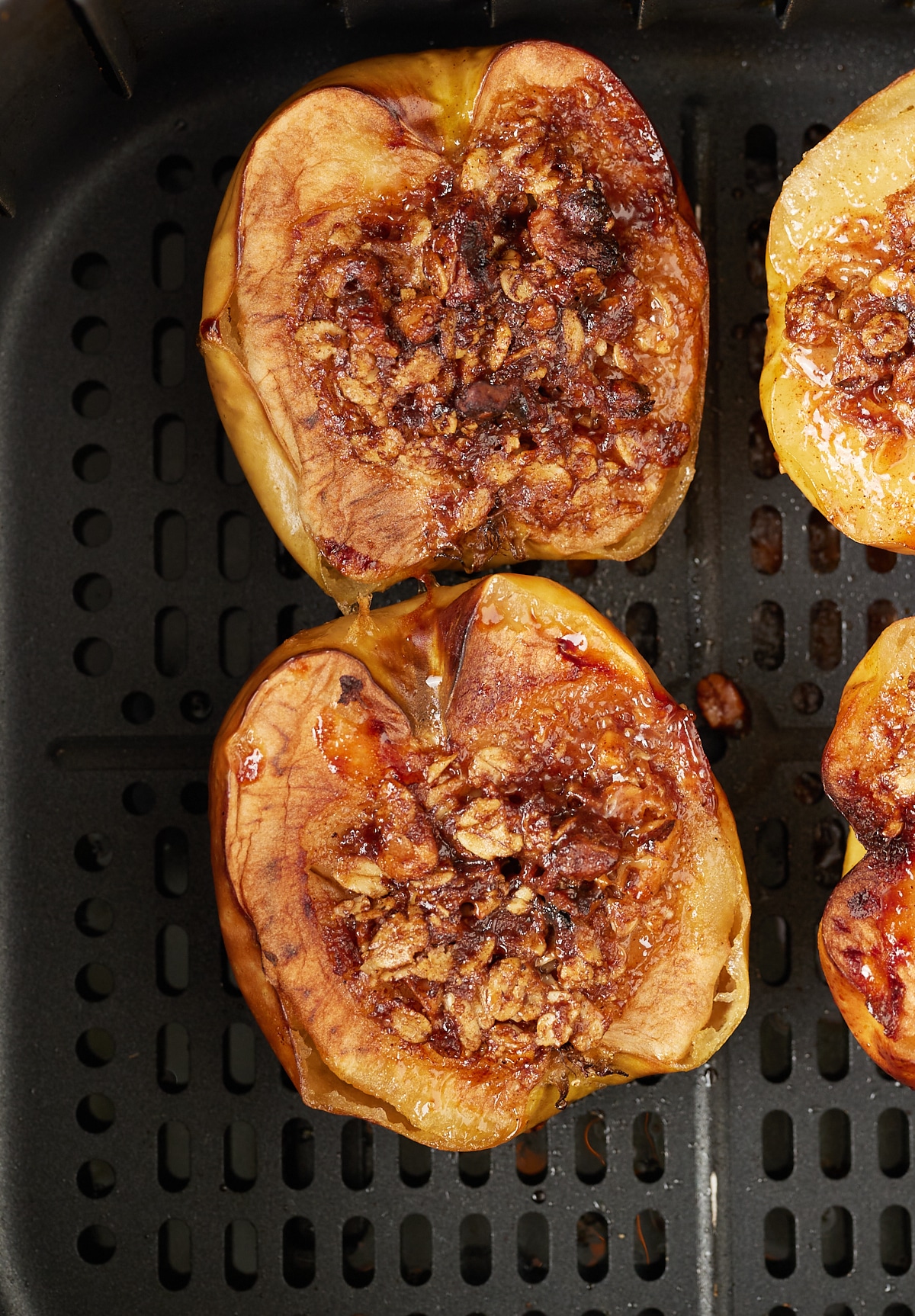 Close up of the baked apples in the air fryer basket.