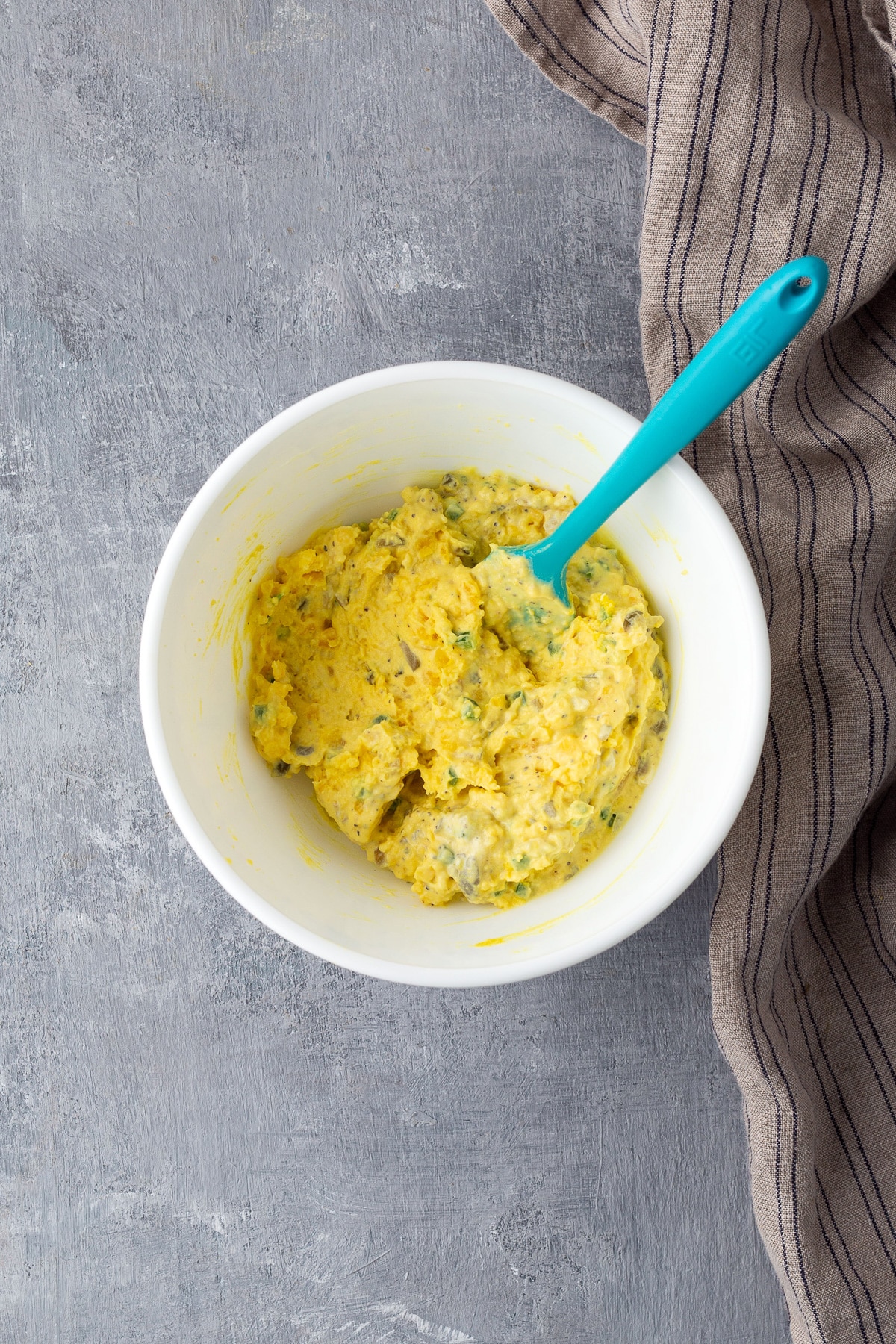 deviled eggs egg yolk mixed with ingredients in white bowl