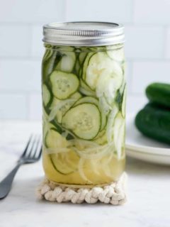 Mason jar filled with cucumber and sweet onion refrigerator pickles