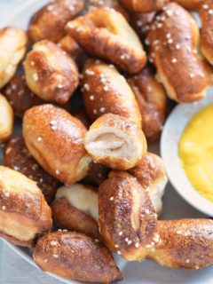 a bowl of air fried pretzel bites and a bowl of mustard dipping sauce