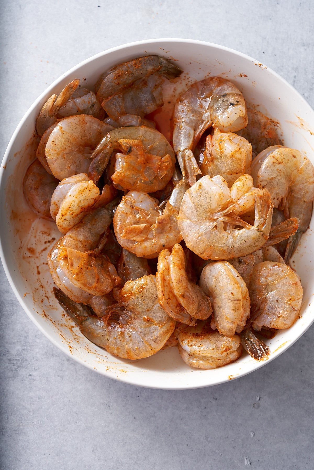 shrimp marinating in white bowl