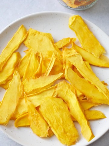 dehydrated mango slices on a white plate