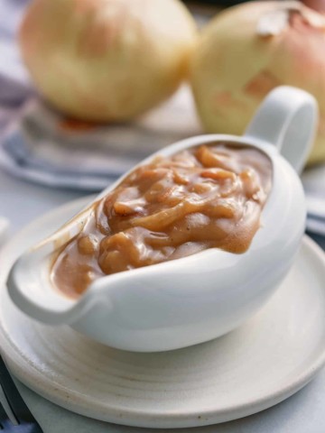 A white gravy jug filled with onion gravy.