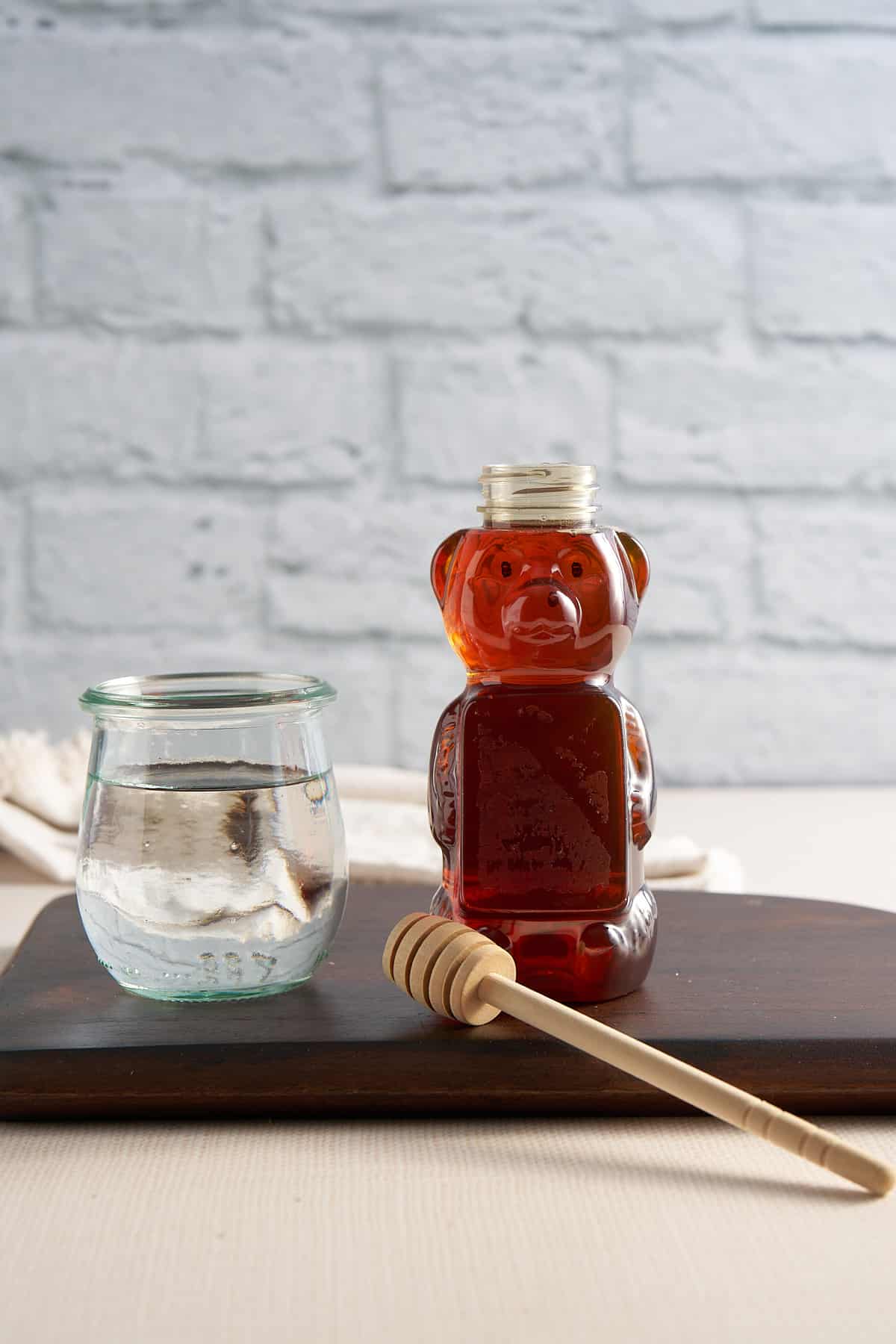 ingredients for honey syrup. the water in a jar and a container of honey