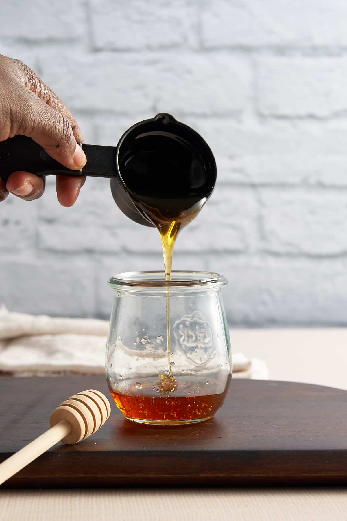 honey being poured into a container