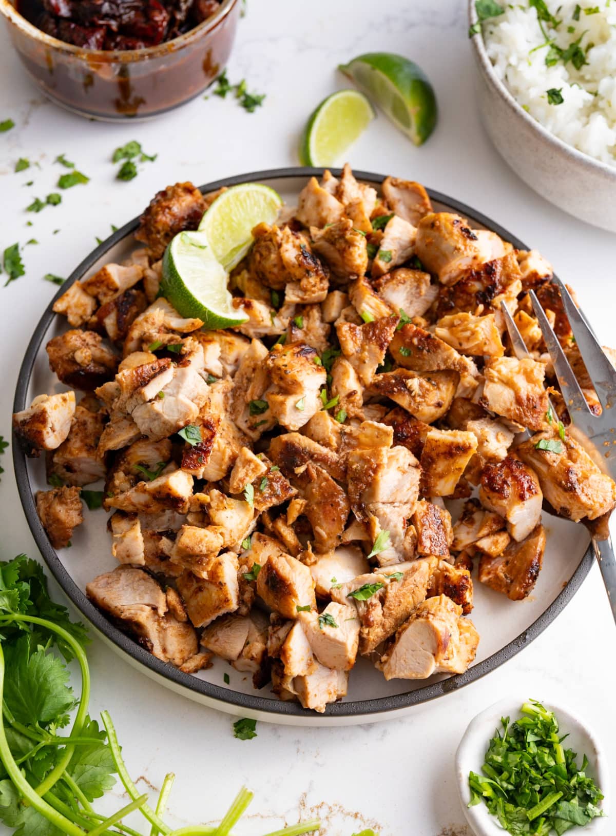 copycat chipotle chicken recipe in plate with ingredients surrounding it