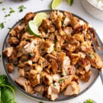 chipotle chicken in plate with ingredients surrounding it