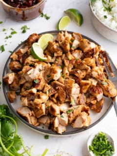 chipotle chicken in plate with ingredients surrounding it