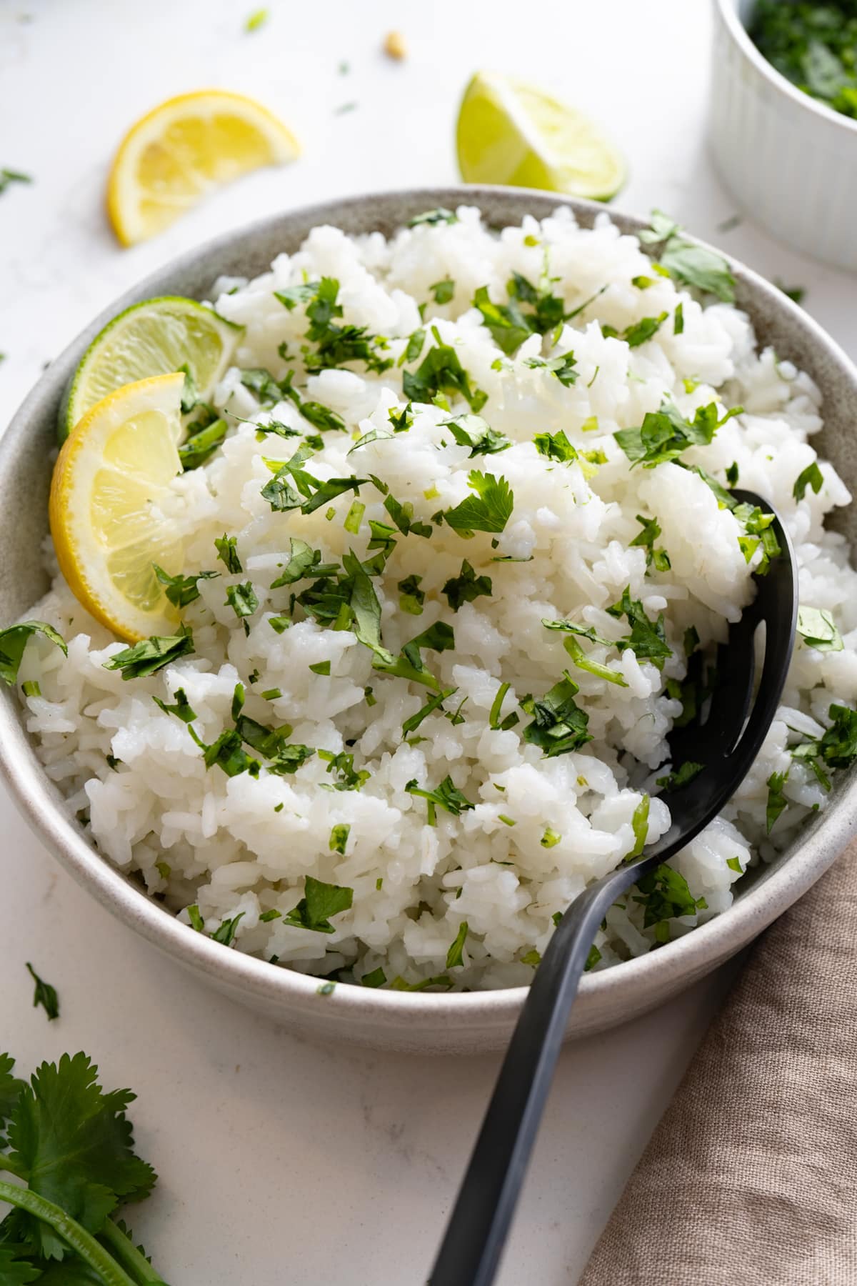 cilantro lime rice in bowl with spoon sticking out