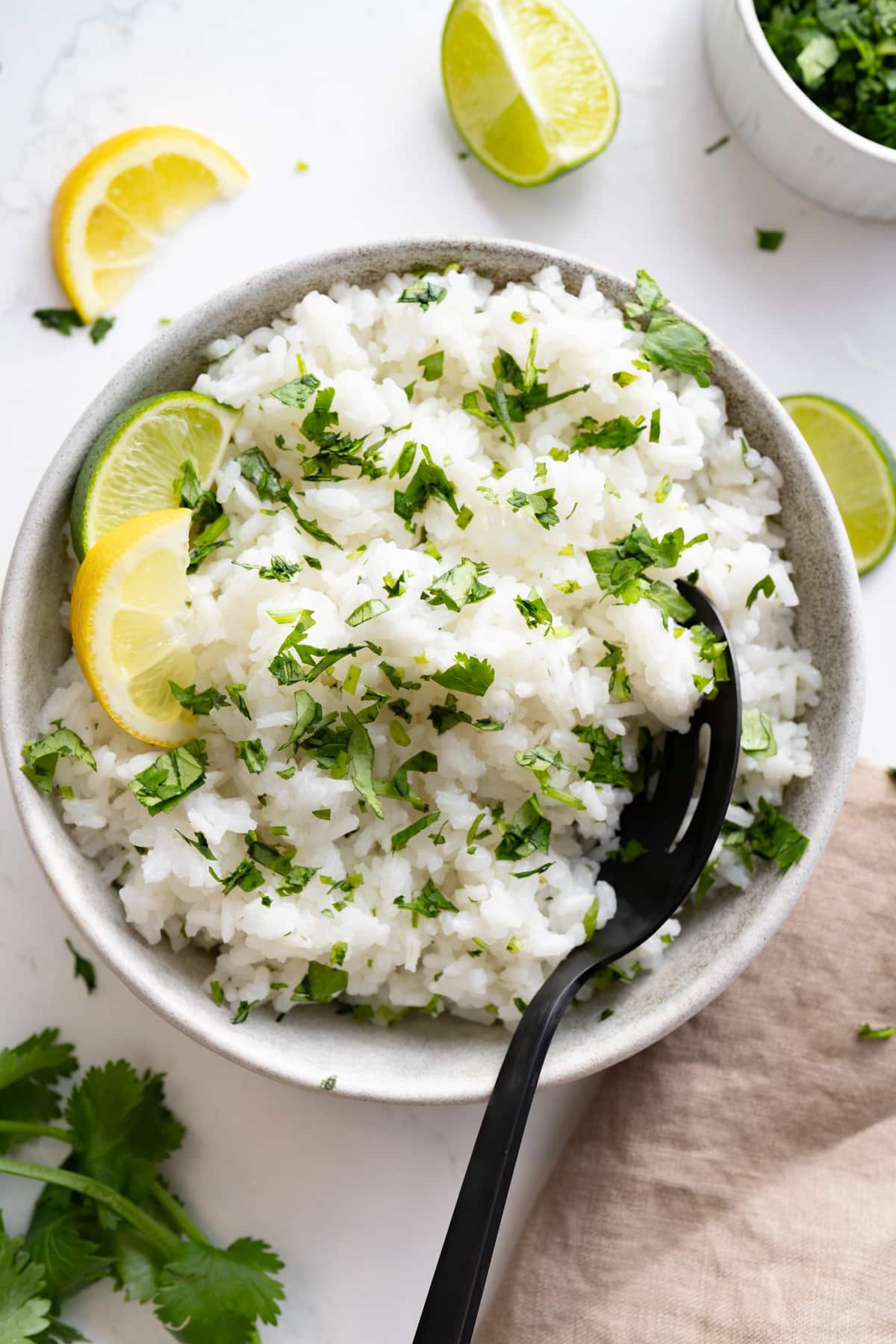 cilantro lime rice in bowl with spoon sticking out