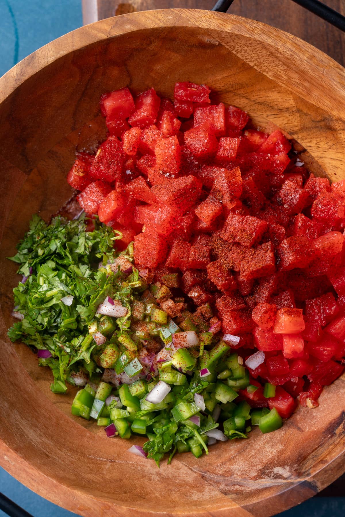 watermelon salsa ingredients in a wooden bowl before mixing