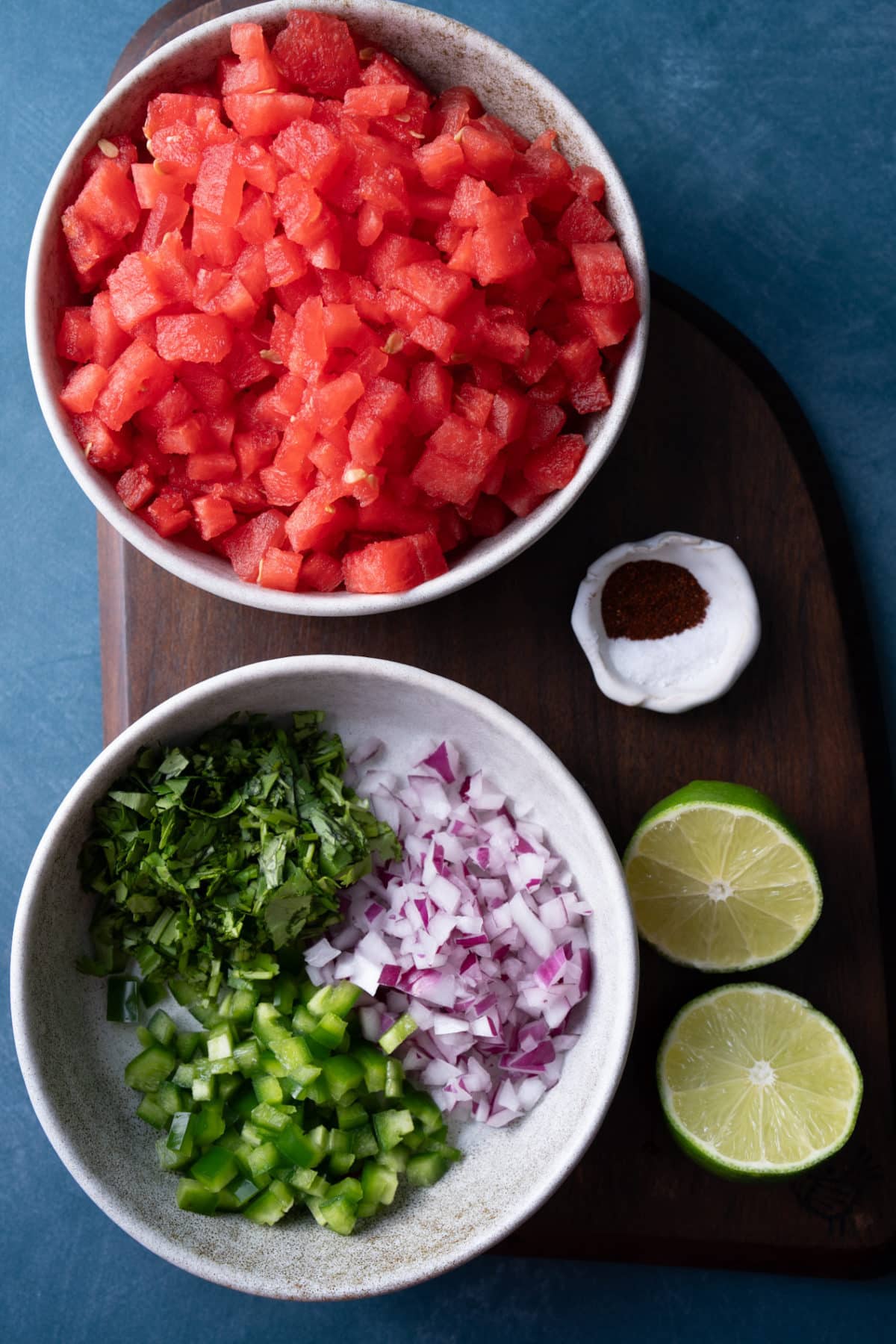 ingredients for watermelon salsa on wooden cutting board