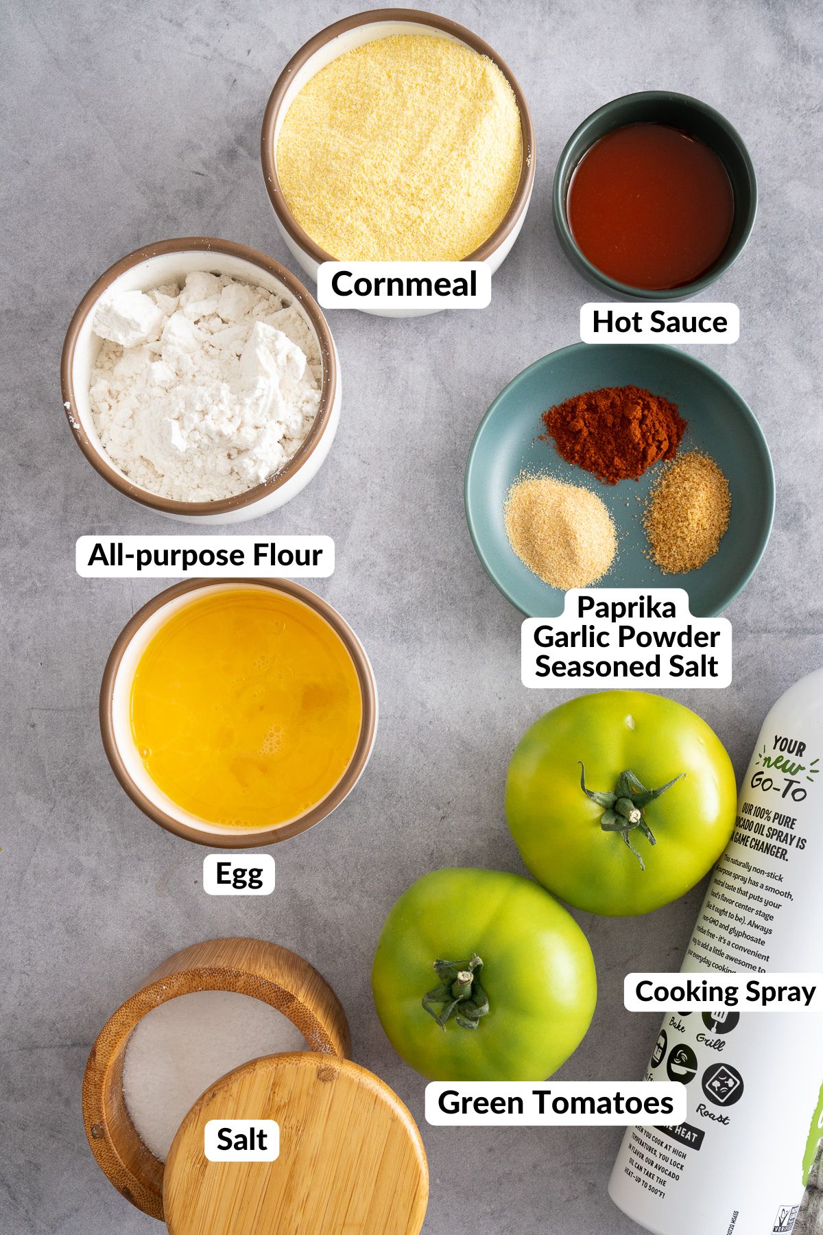 fried green tomatoes with ingredients written on that say all-purpose flour, cornmeal, hot sauce, paprika, garlic powder, seasoned salt, green tomatoes, salt, cooking spray