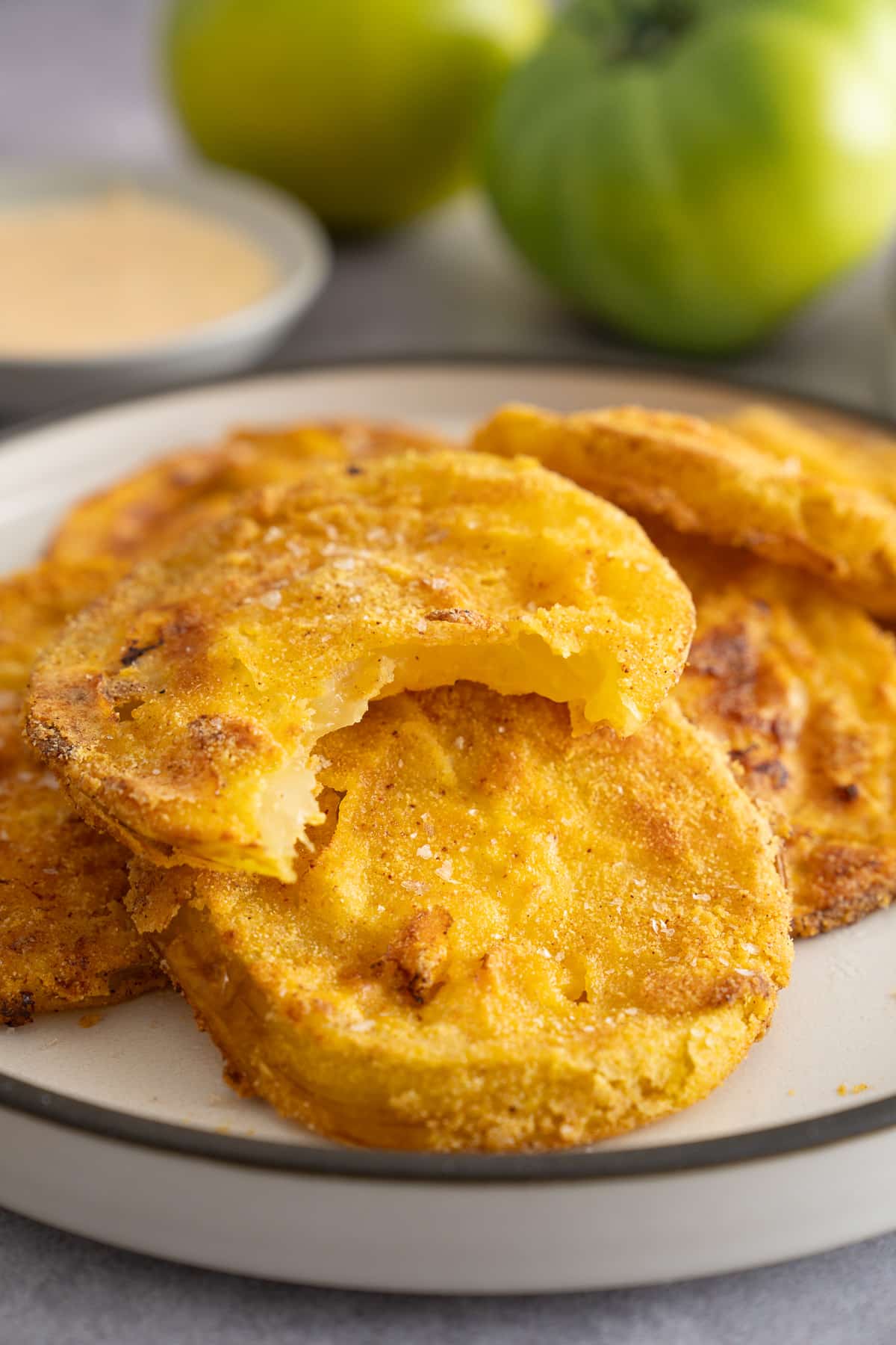 air fryer fried green tomato with one bite taken out