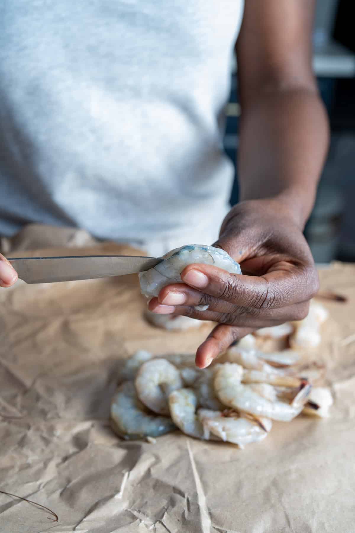 shrimp being cut on back to remove vein