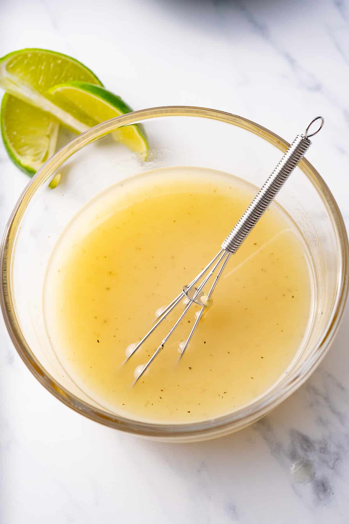 lime vinaigrette in bowl after whisking with whisk inside