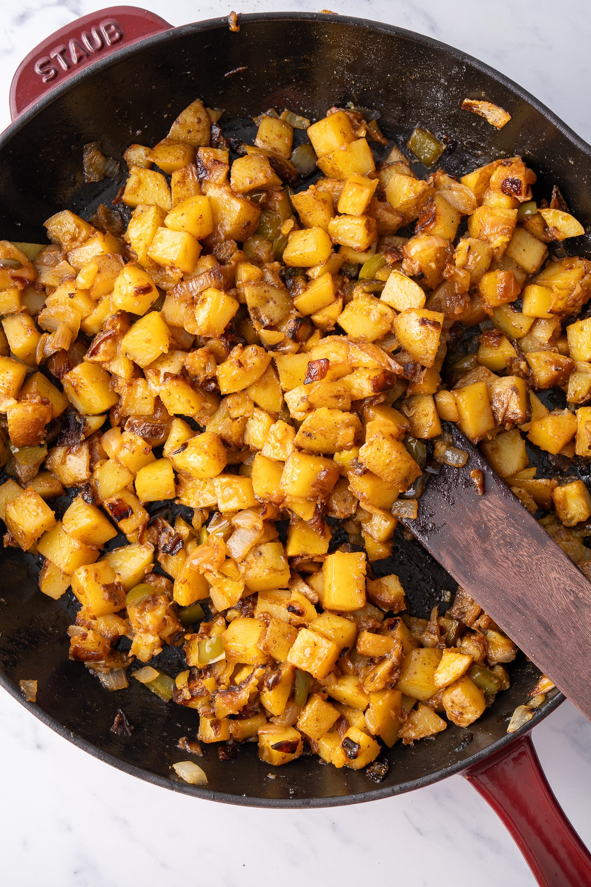 cooked smothered potatoes  in skillet