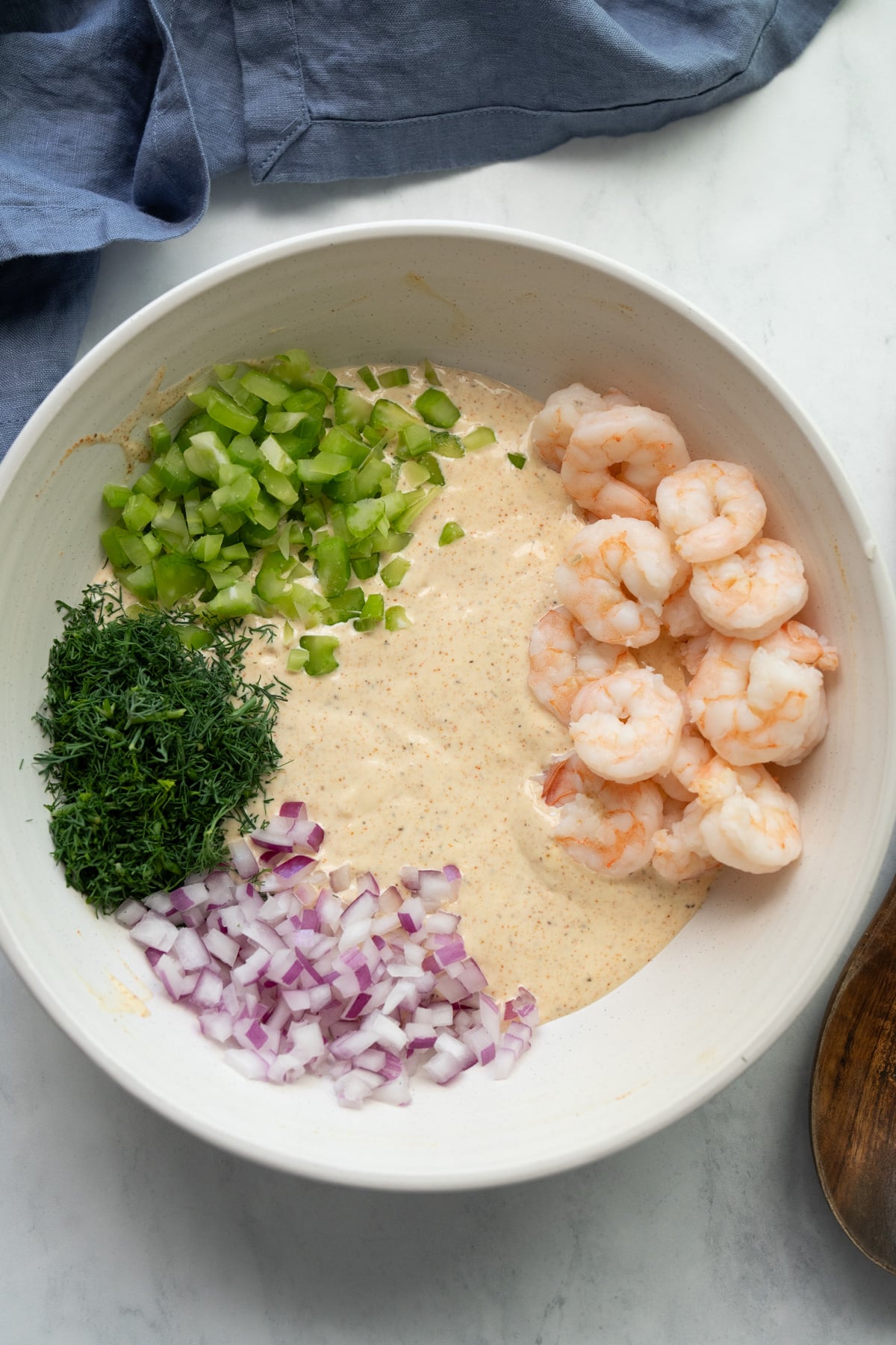 Shrimp salad ingredients in bowl before mixing