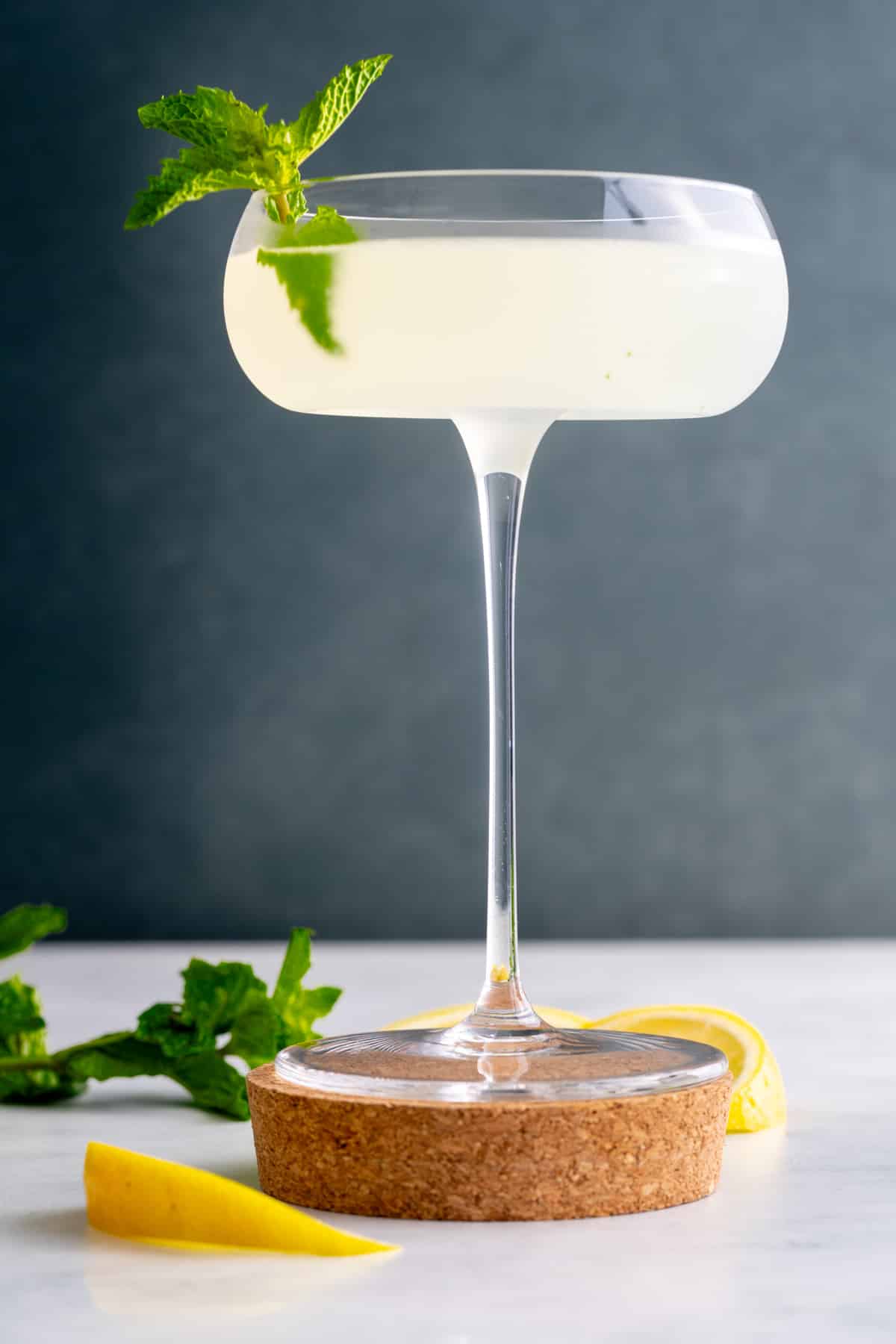 southside cocktail in glass with mint on side