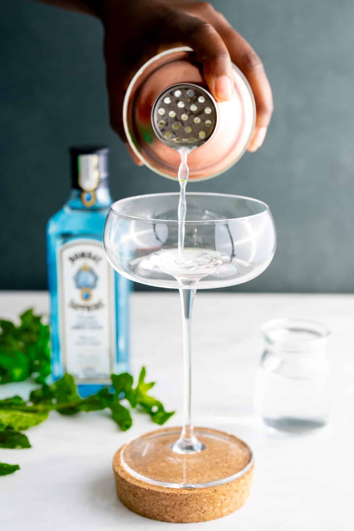 cocktail being poured into glass