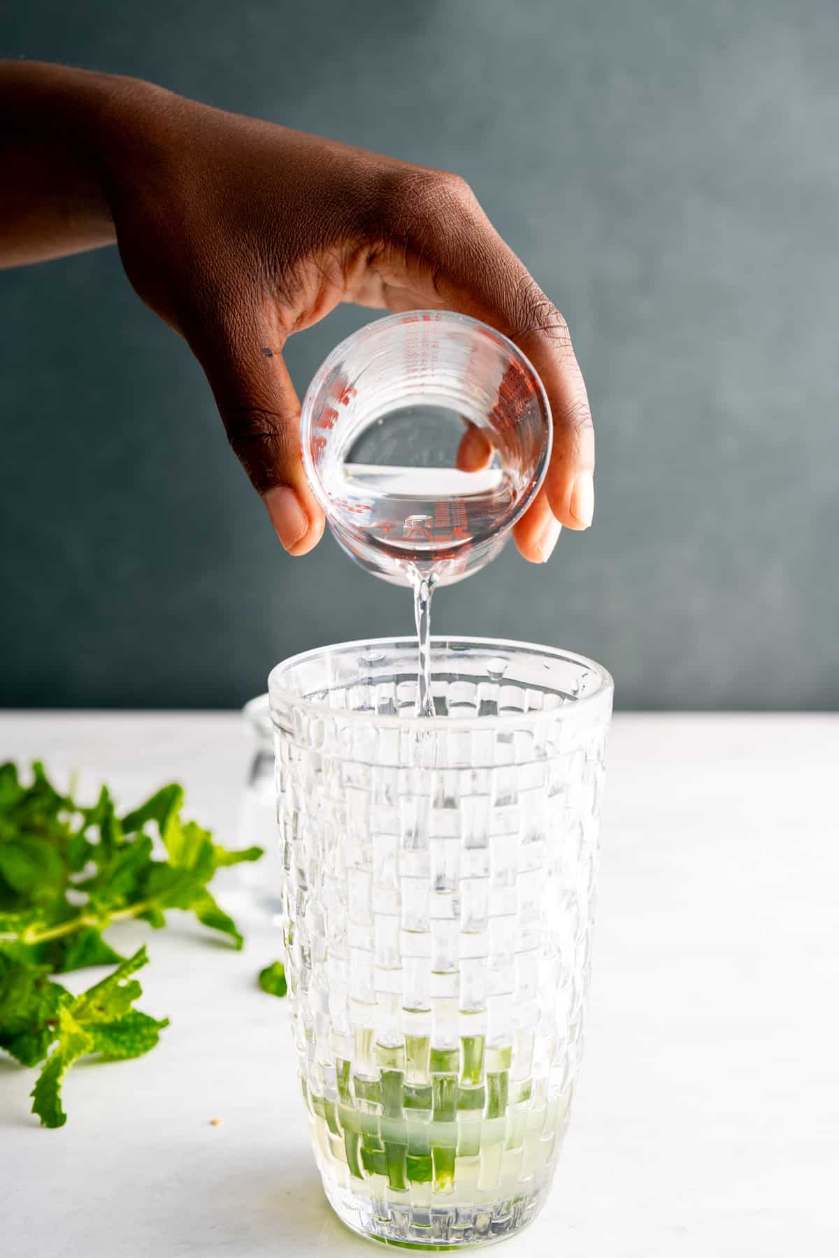 drink being poured into coktail shaker