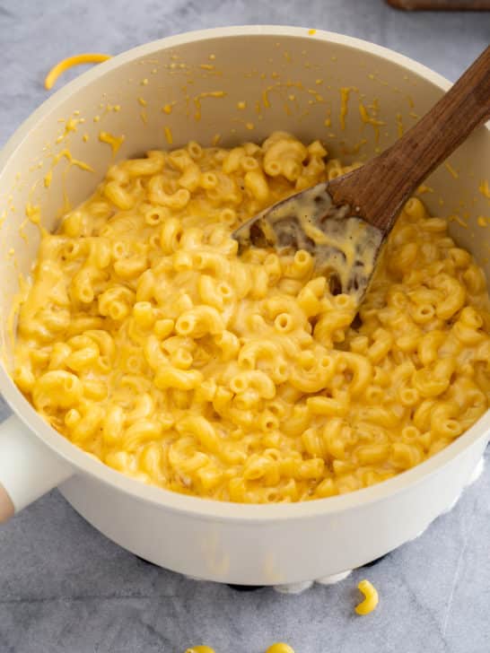 stovetop mac and cheese in a pot with spoon sticking out