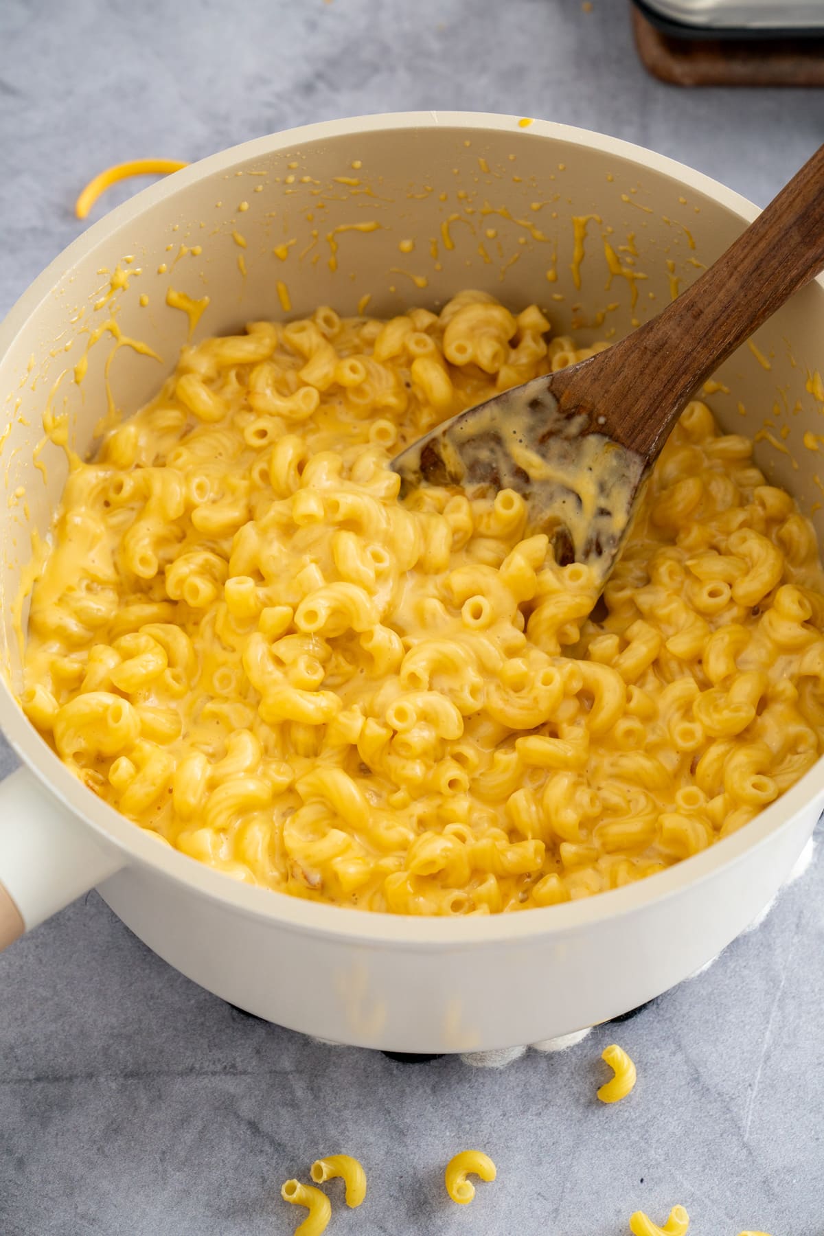 stovetop mac and cheese in a pot with spoon sticking out