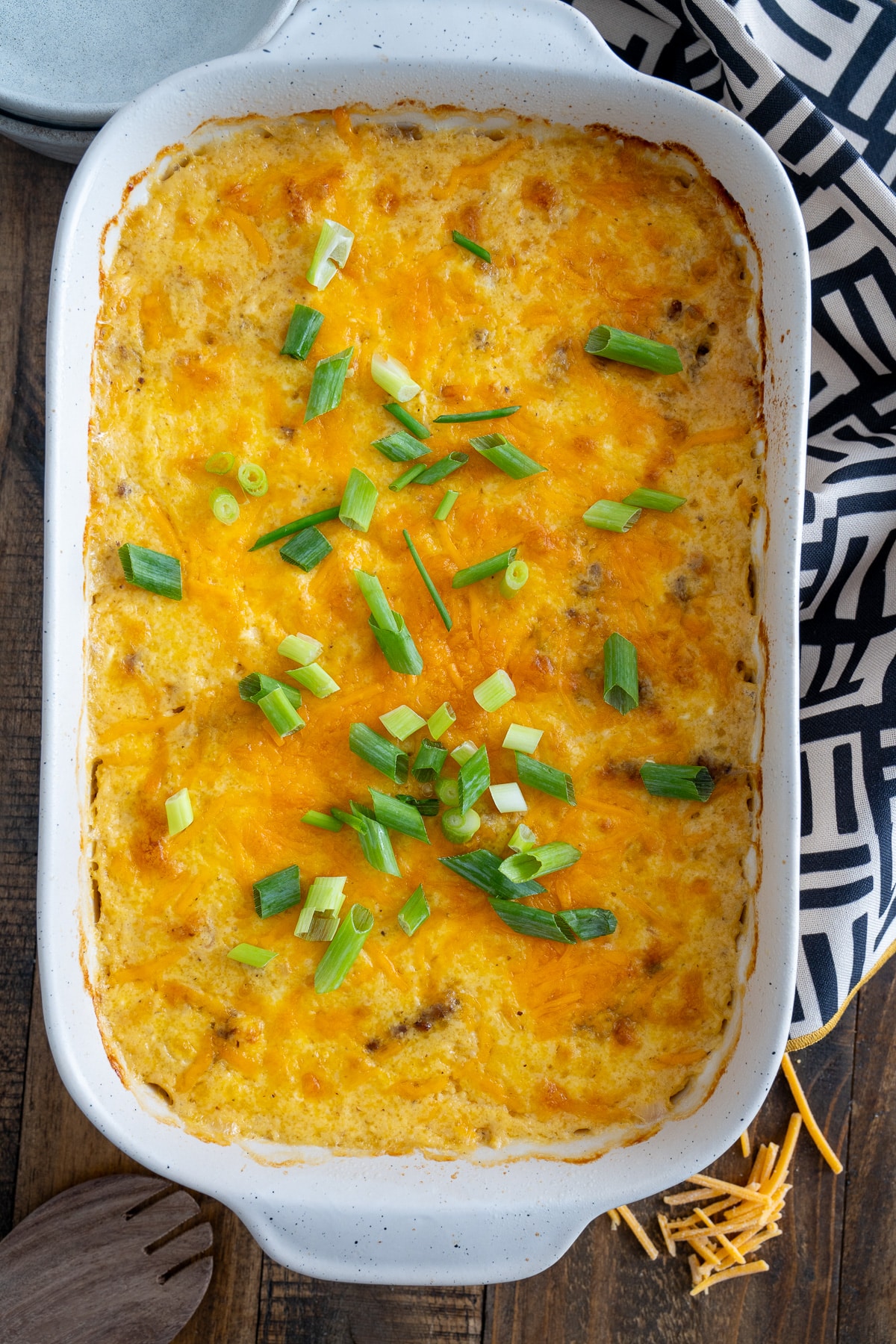 baked grits casserole with melted cheese and green onions on top