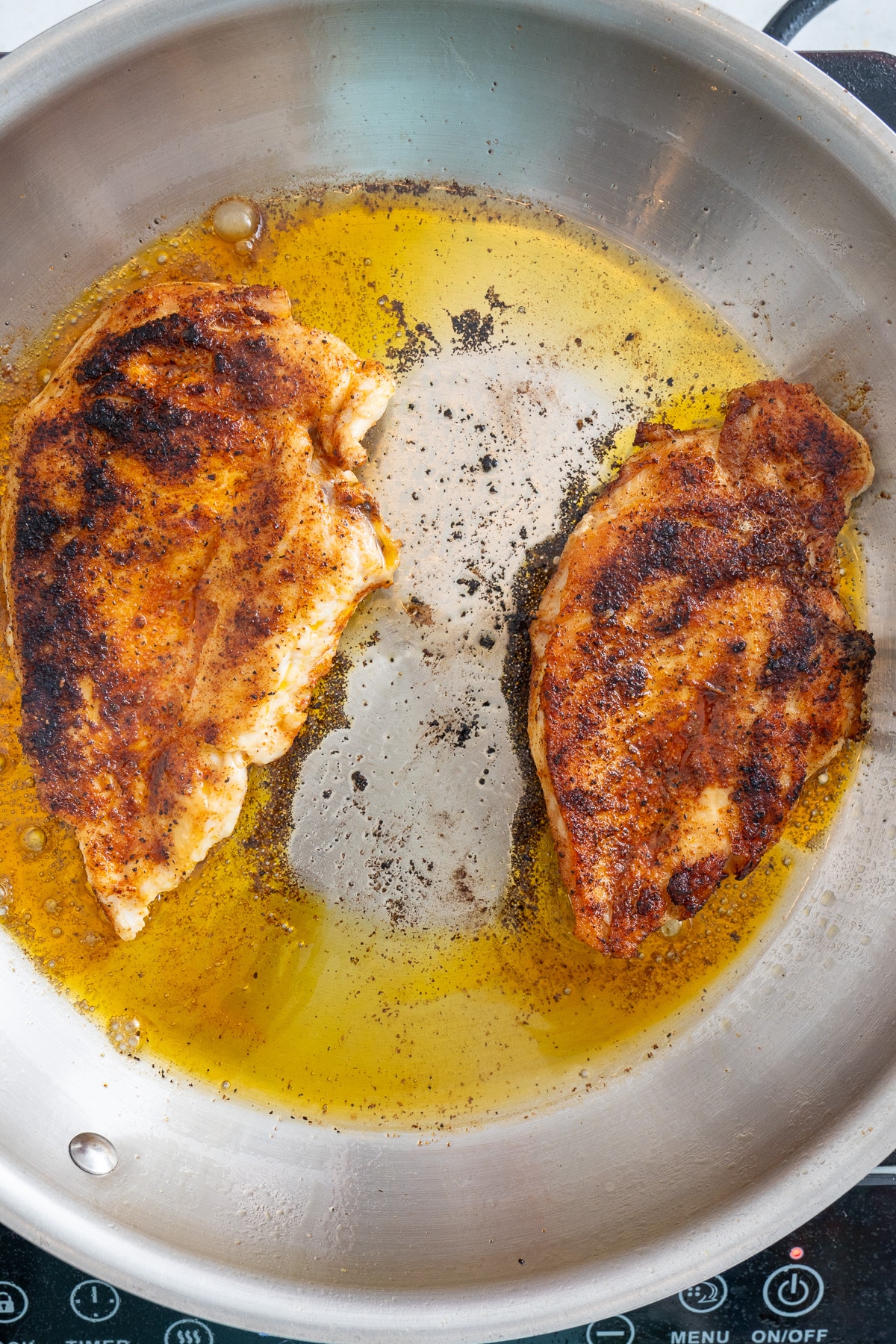 cooked chicken breast in skillet