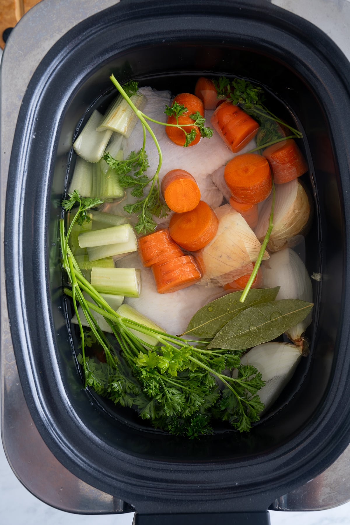 chicken and vegetables and water raw in slow cooker