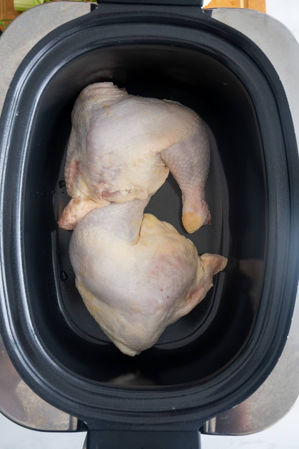 chicken quarters in bottom of slow cooker insert