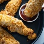 chicken tender being dipped in sauce