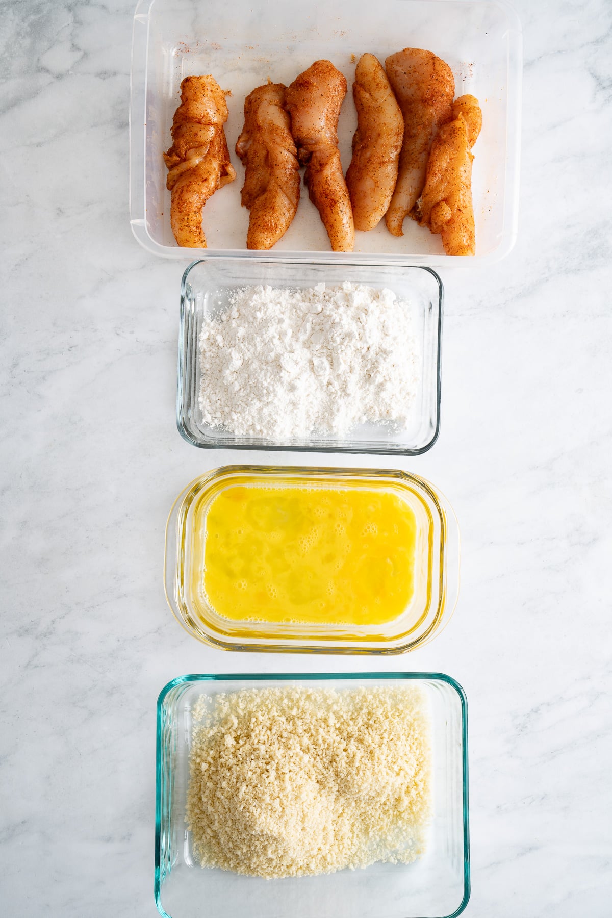 ingredients for air fryer chicken tenders set up to be breaded